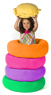 Girl with stack of Cozy Puff dog beds